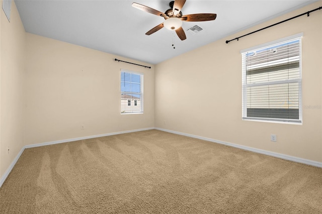 carpeted spare room featuring ceiling fan