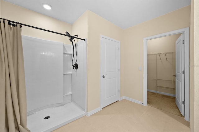 bathroom featuring tile patterned flooring and walk in shower