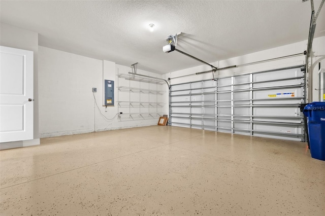 garage with a garage door opener and electric panel