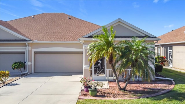 view of front of home featuring a garage, driveway, a shingled roof, and stucco siding