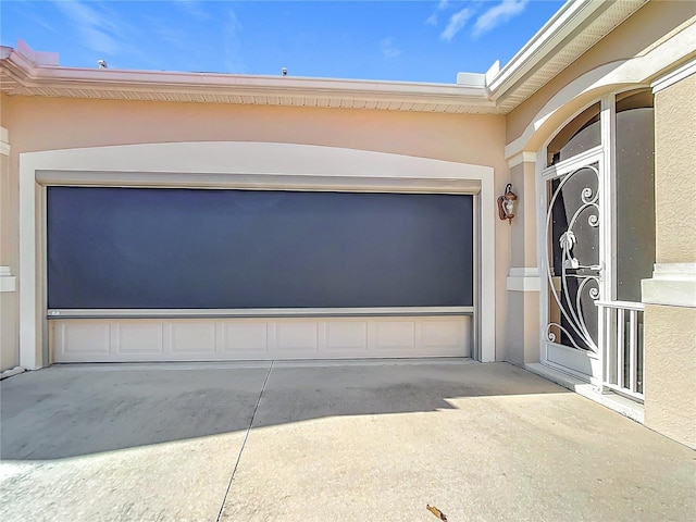 garage featuring concrete driveway