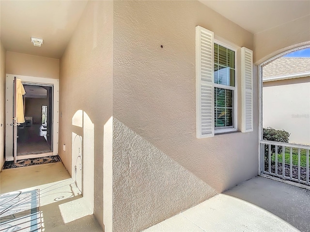 property entrance featuring stucco siding