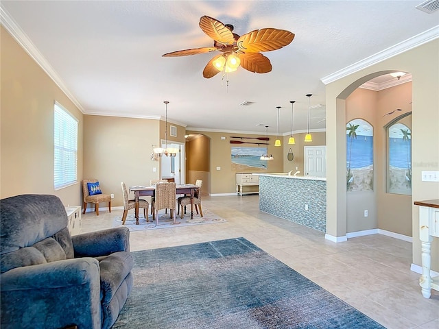 living room featuring ceiling fan with notable chandelier, ornamental molding, and light tile patterned floors