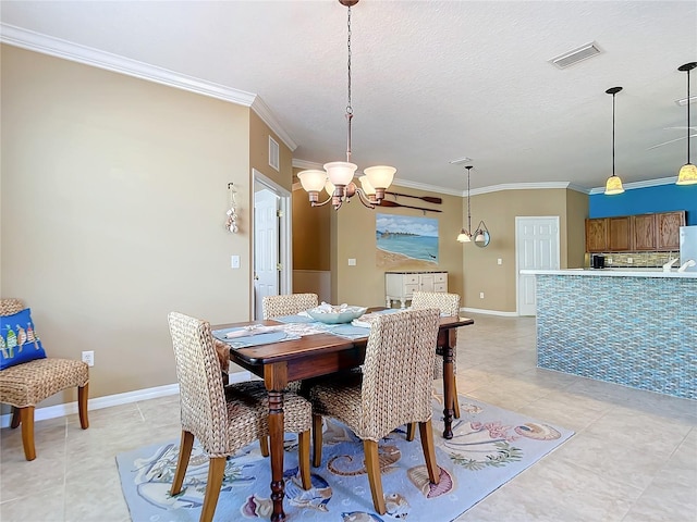 dining space with a textured ceiling, an inviting chandelier, ornamental molding, and light tile patterned flooring