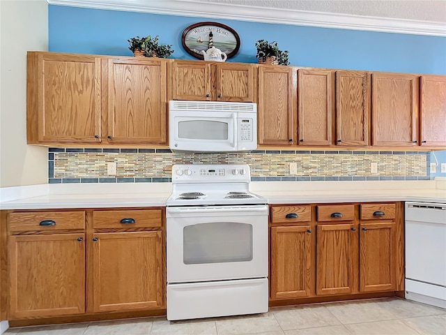 kitchen featuring light countertops, white appliances, backsplash, and crown molding