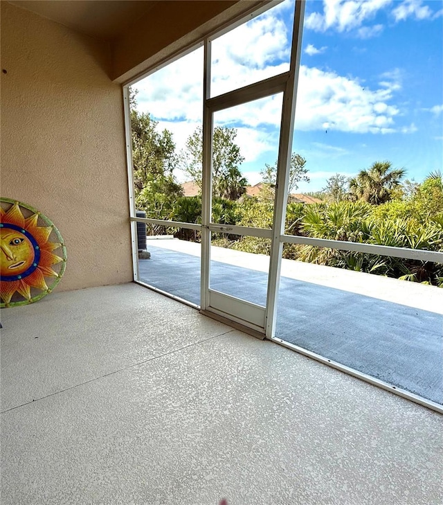 doorway to outside featuring a textured wall