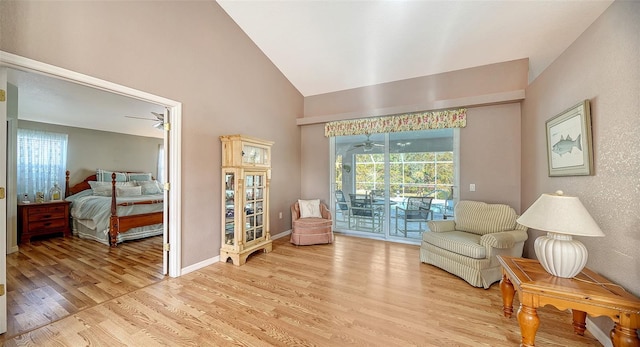 living area featuring light wood-type flooring and lofted ceiling