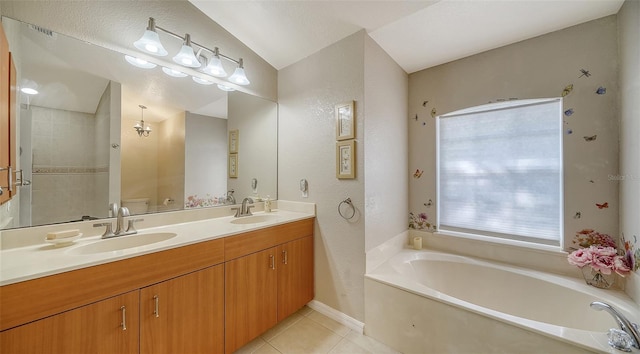 bathroom with tile patterned flooring, a bath, vanity, and toilet