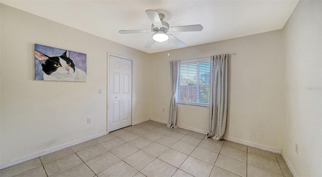 unfurnished room featuring light tile patterned floors and ceiling fan