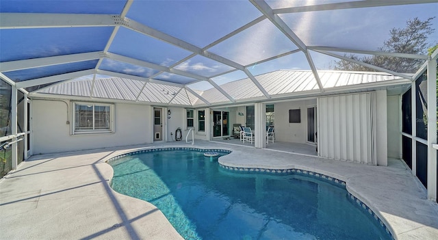 view of pool with a patio area and a lanai