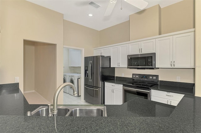 kitchen with washing machine and clothes dryer, sink, white cabinets, and stainless steel appliances