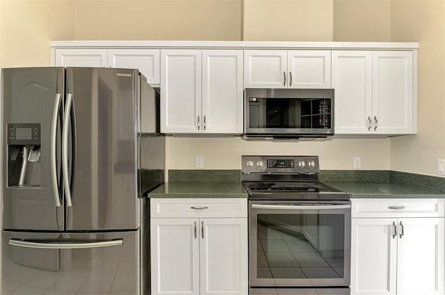 kitchen with stainless steel appliances and white cabinetry