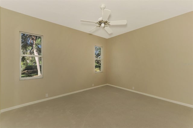 carpeted empty room featuring ceiling fan