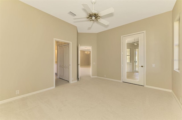 empty room featuring ceiling fan and light colored carpet