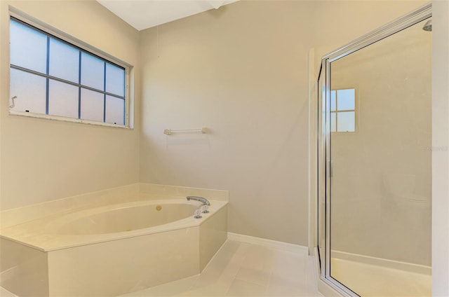 bathroom featuring tile patterned floors and independent shower and bath