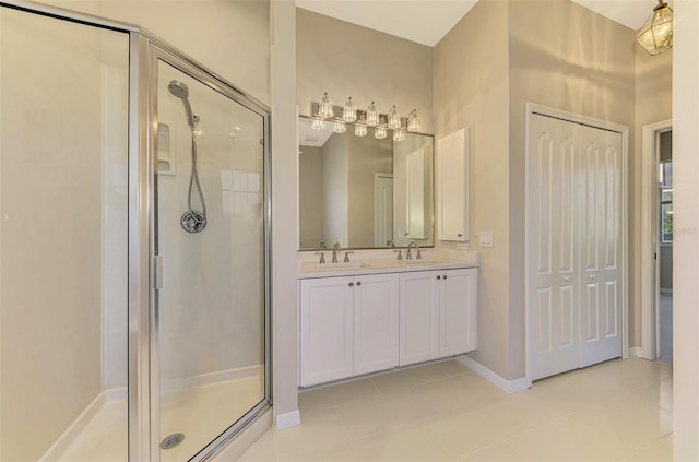 bathroom with tile patterned flooring, vanity, and a shower with shower door