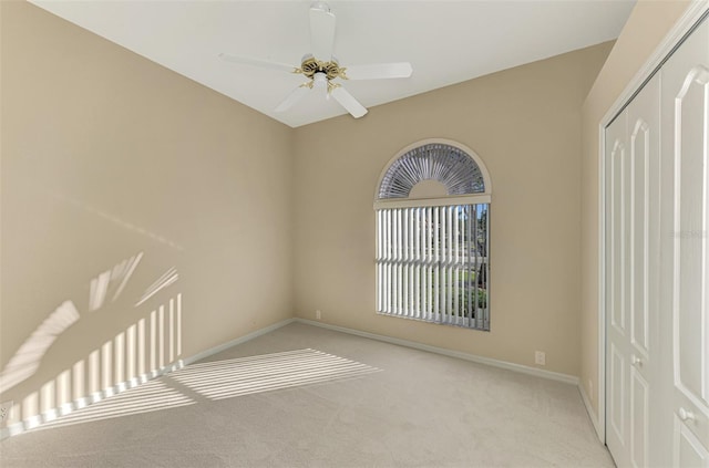 carpeted empty room with ceiling fan