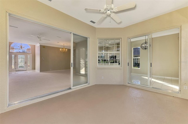 interior space featuring ceiling fan with notable chandelier