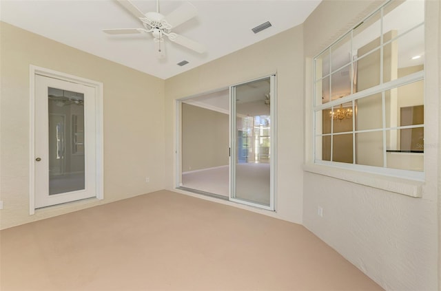 interior space featuring ceiling fan with notable chandelier