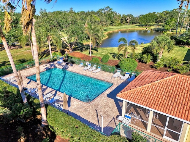 view of swimming pool featuring a patio area and a water view