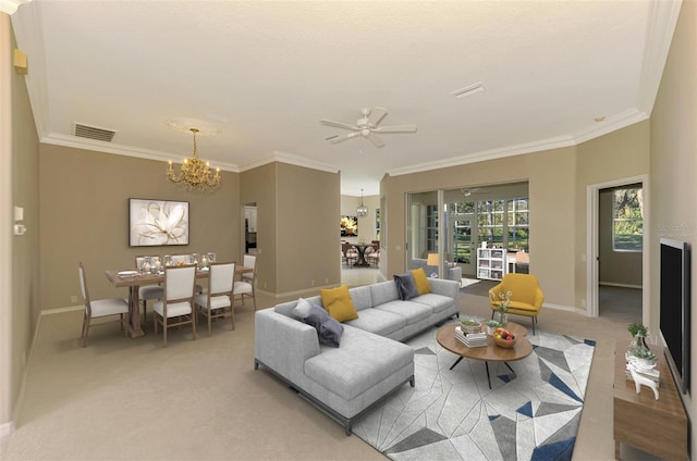 carpeted living room with ceiling fan with notable chandelier and crown molding