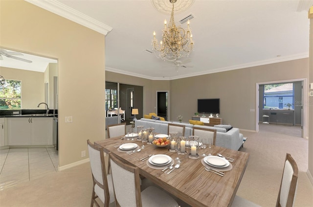 carpeted dining area featuring ceiling fan with notable chandelier, sink, plenty of natural light, and ornamental molding