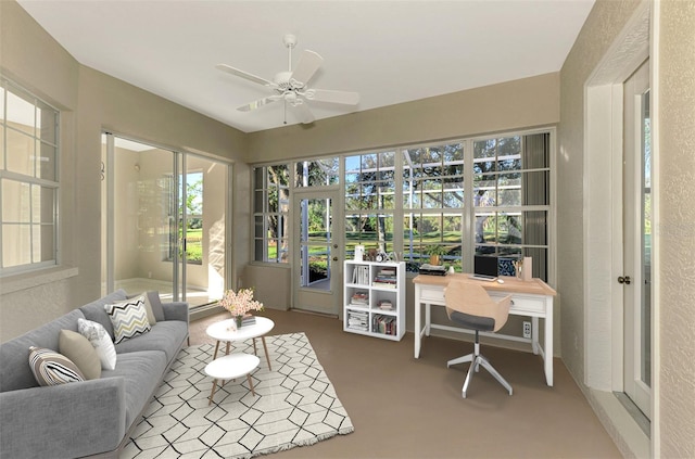 sunroom / solarium featuring ceiling fan