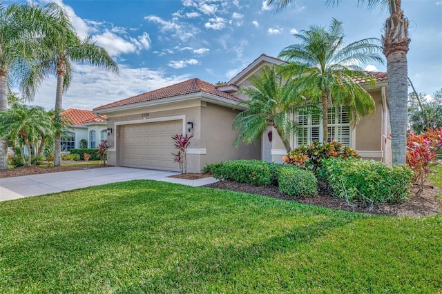 mediterranean / spanish-style home with a front yard and a garage