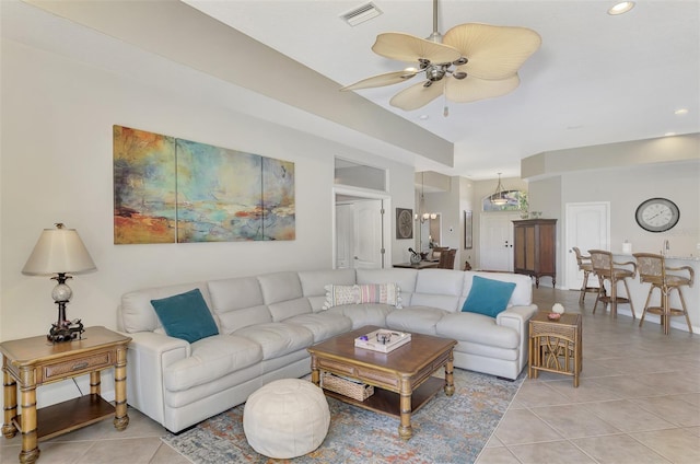 living room featuring light tile patterned floors and ceiling fan