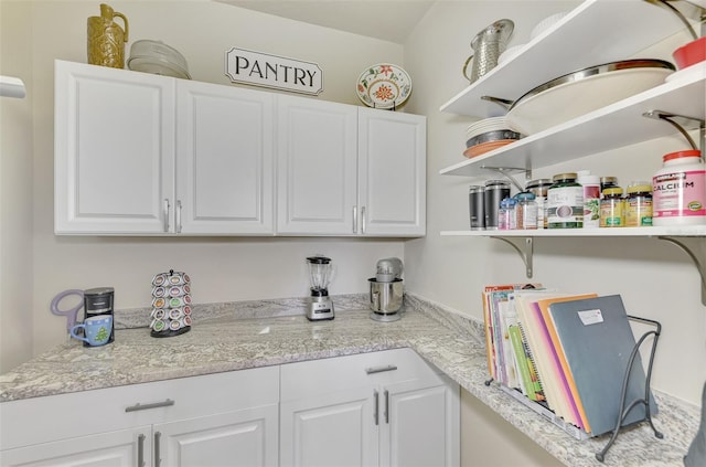 kitchen with white cabinets and light stone countertops