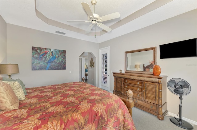 bedroom with a raised ceiling, ceiling fan, access to exterior, and carpet floors