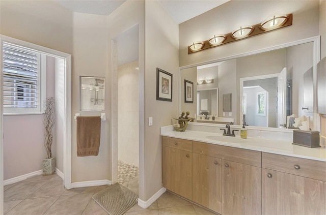 bathroom featuring tile patterned floors, a shower, and vanity