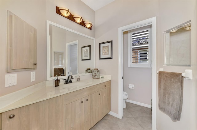 bathroom with tile patterned flooring, vanity, and toilet