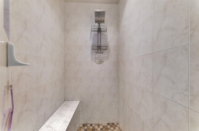 bathroom with tiled shower