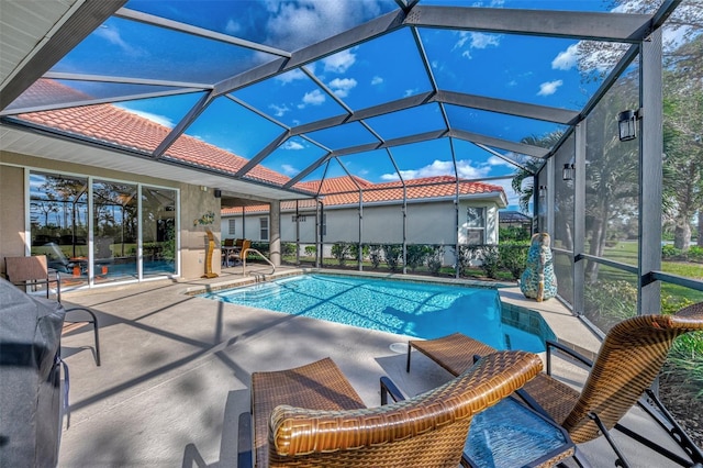 view of swimming pool featuring a patio area and glass enclosure