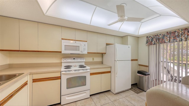 kitchen featuring ceiling fan, white appliances, light tile patterned floors, and cream cabinets