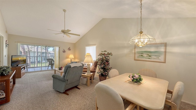 dining space with high vaulted ceiling, light colored carpet, and ceiling fan with notable chandelier