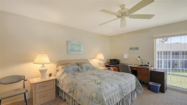 carpeted bedroom featuring ceiling fan and a textured ceiling