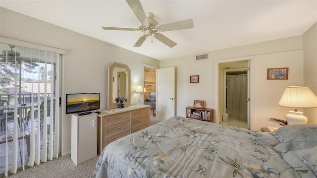 carpeted bedroom featuring access to exterior, ceiling fan, ensuite bathroom, and a textured ceiling