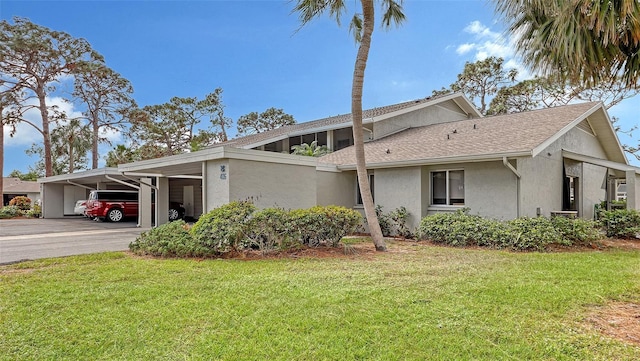 view of side of home featuring a lawn and a carport