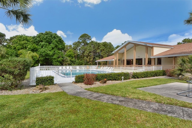 view of pool with a patio area and a yard