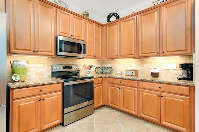 kitchen featuring crown molding, light tile patterned floors, stainless steel appliances, and light stone counters