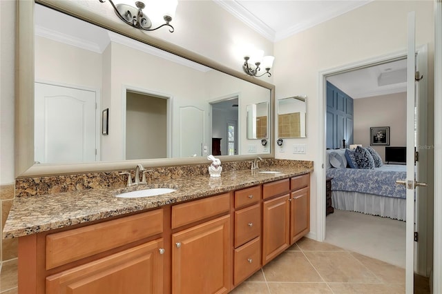 bathroom with crown molding, tile patterned flooring, and vanity