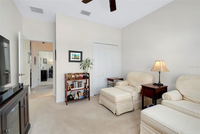 sitting room with light colored carpet and ceiling fan