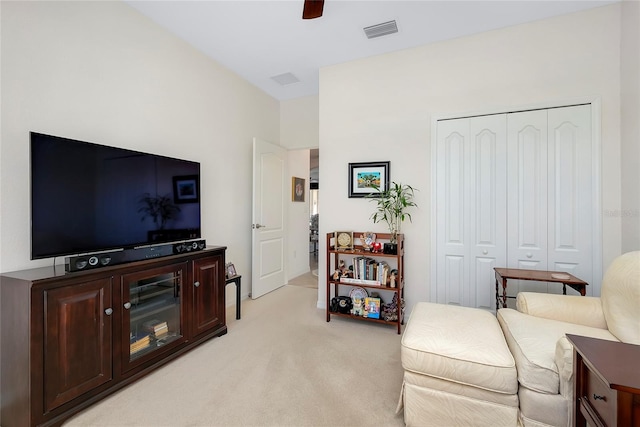 sitting room featuring light carpet