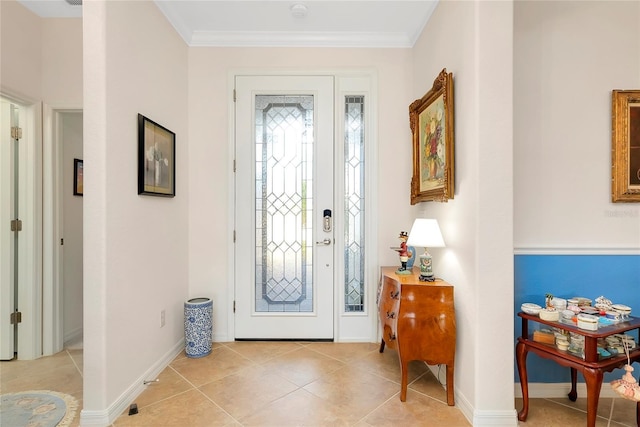 tiled entrance foyer featuring crown molding