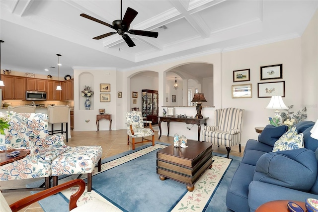 tiled living room featuring crown molding, beamed ceiling, ceiling fan, and coffered ceiling