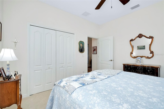 bedroom featuring ceiling fan, a closet, and light colored carpet