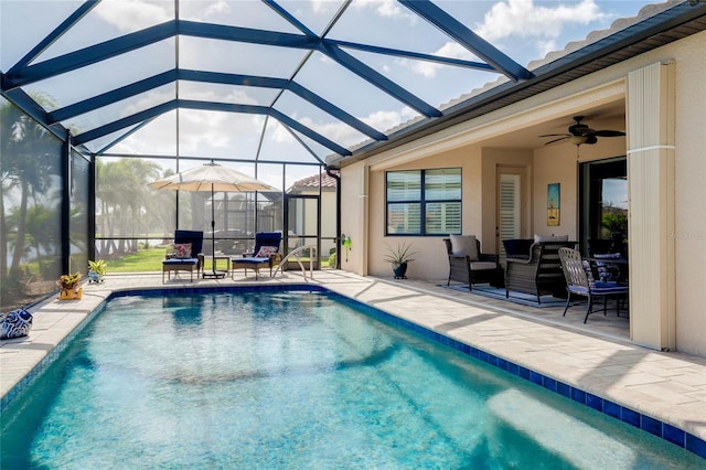 view of pool featuring a lanai, ceiling fan, and a patio area