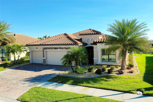 mediterranean / spanish house with a garage and a front lawn